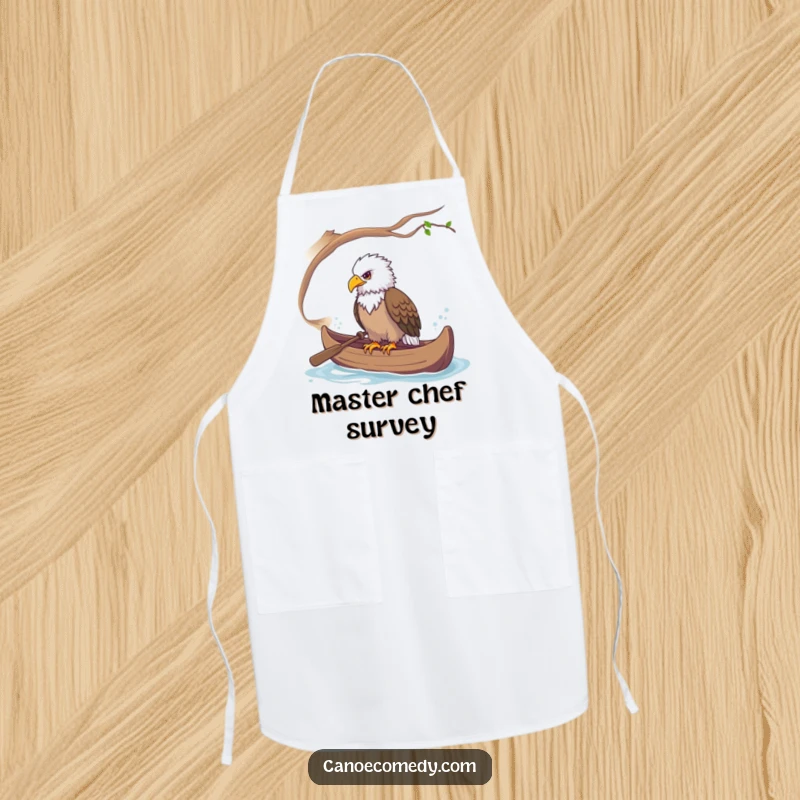 Funny apron illustration of a majestic eagle perched in a canoe, observing the kitchen with keen interest.