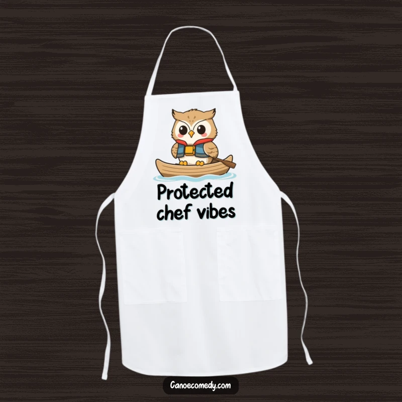 Funny owl apron, depicted smiling in a canoe while wearing a life vest, a humorous and practical culinary accessory.