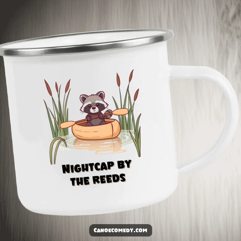 Funny enamel camping mug featuring a raccoon navigating a canoe through reeds, perfect for outdoor beverages.