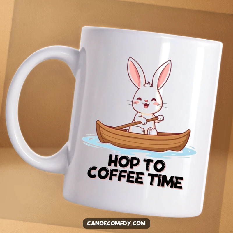Funny rabbit mug showing a happy rabbit with comically large ears paddling a canoe with enthusiasm.