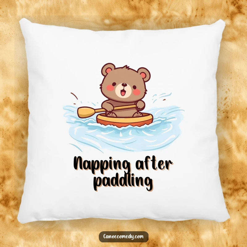 Funny decorative pillow featuring a bear happily paddling a canoe down a river, adding comfort and humor to any space.