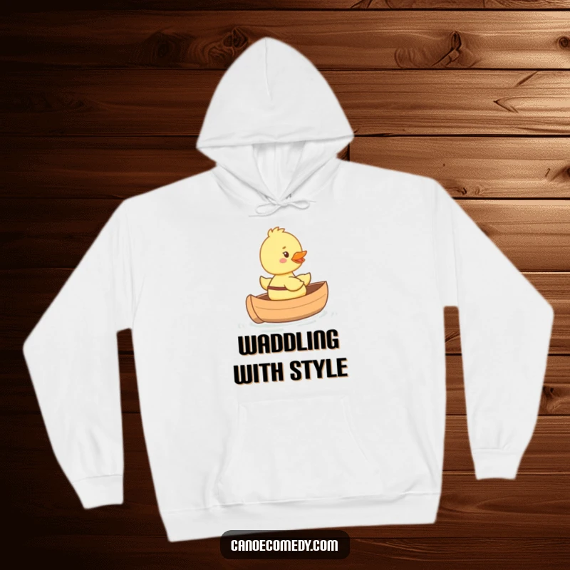 Funny happy duckling hoodie riding in a tiny canoe with a big smile, cozy and adorable design for ultimate comfort.