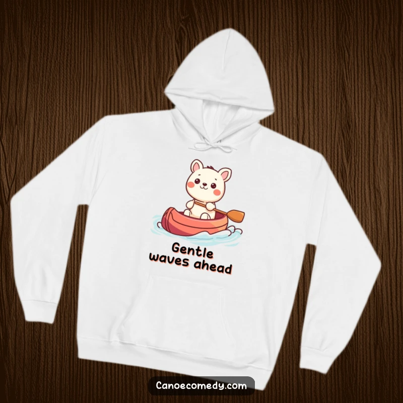 Funny Kawaii animal character steering a colorful canoe through gentle waves, depicted on a warm hoodie, offering comfort and humor.