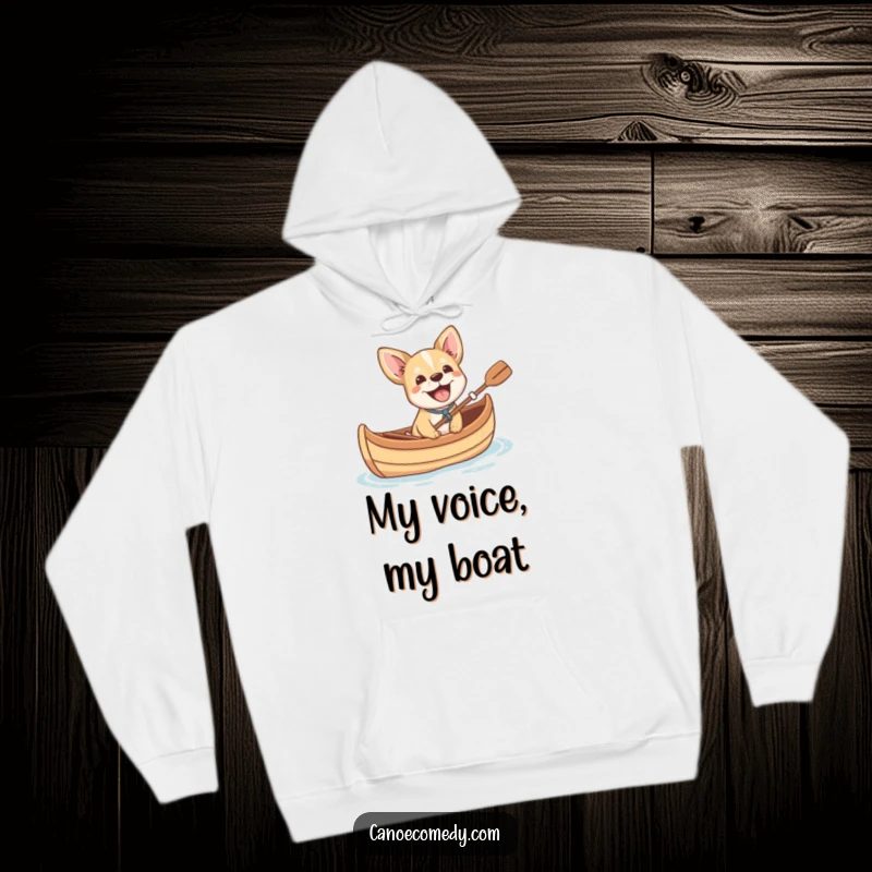 Funny small dog cheerfully barking with excitement from a canoe, a cozy and humorous hoodie for ultimate comfort and pet love.