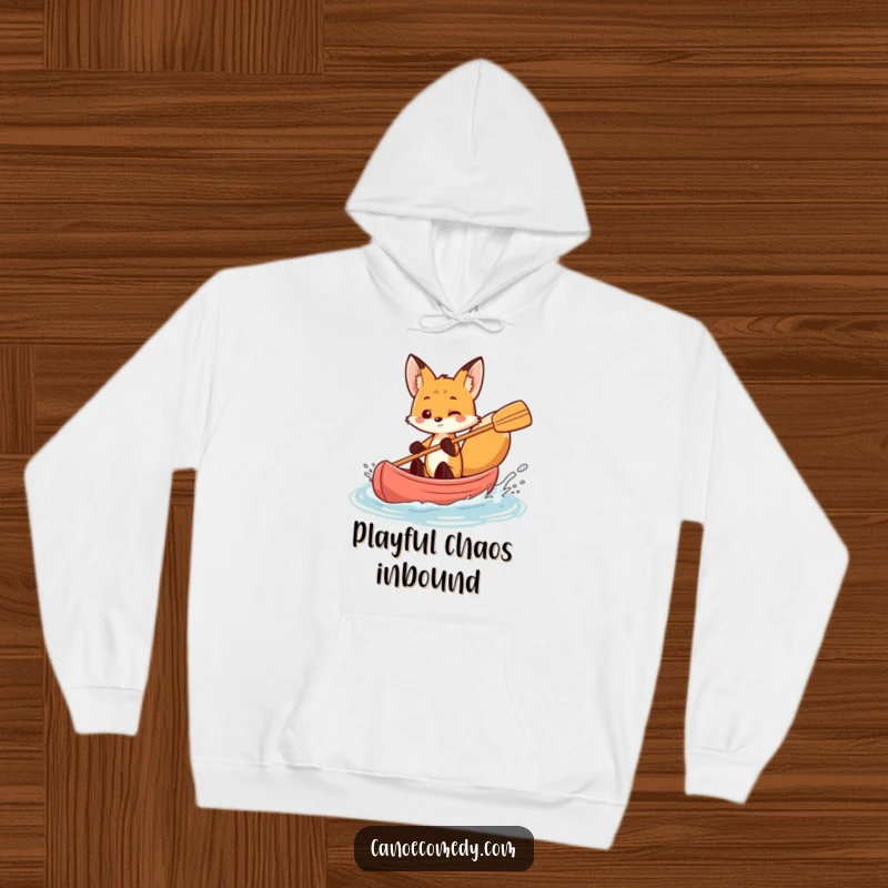 Funny fox in a canoe, playfully splashing water, cozy hoodie design, adventurous animal graphic.