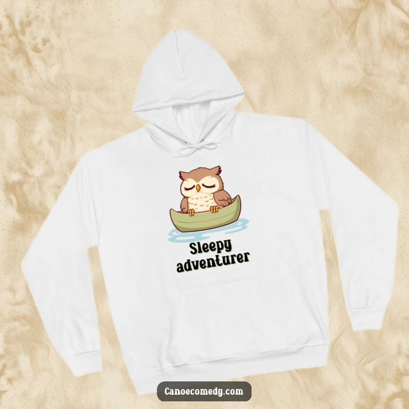 Funny owl hoodie, illustrated peacefully dozing in a canoe, offering warmth and a humorous reminder to rest.