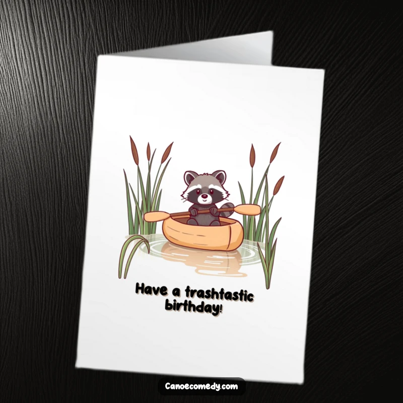 Funny Free Printable Birthday Card: A raccoon expertly navigating a canoe through reeds, perfect for a unique and cheeky greeting.