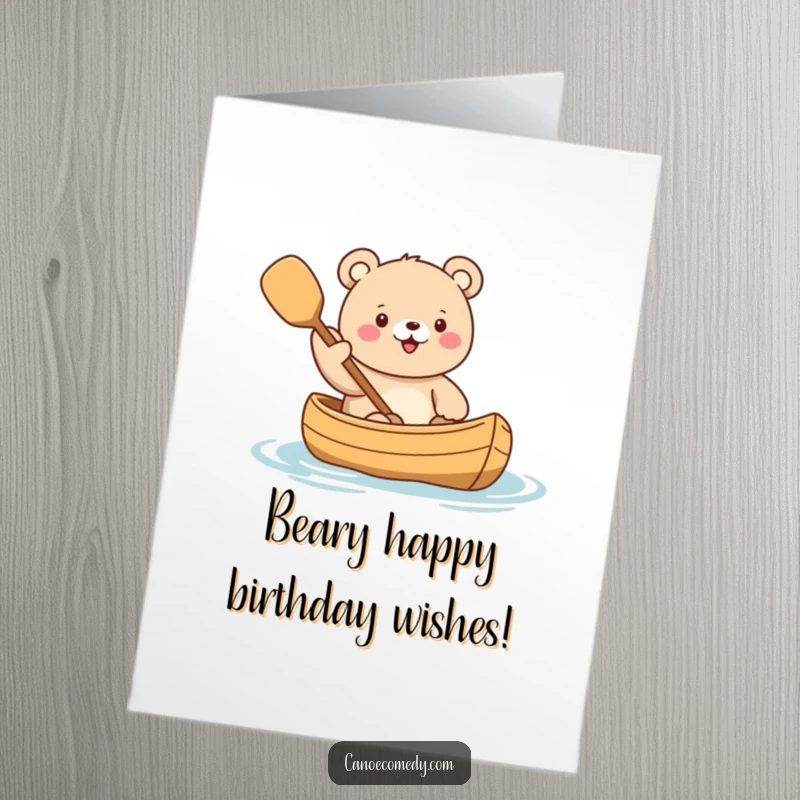 Funny free printable birthday card showing a cute kawaii bear in a canoe, enthusiastically waving a paddle with a joyful expression.