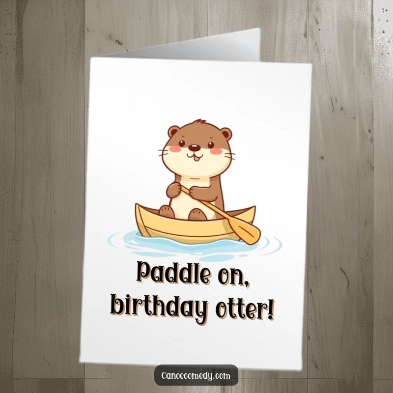 Free Printable Birthday Card: A happy kawaii otter in a small canoe, enthusiastically paddling towards your birthday celebration.