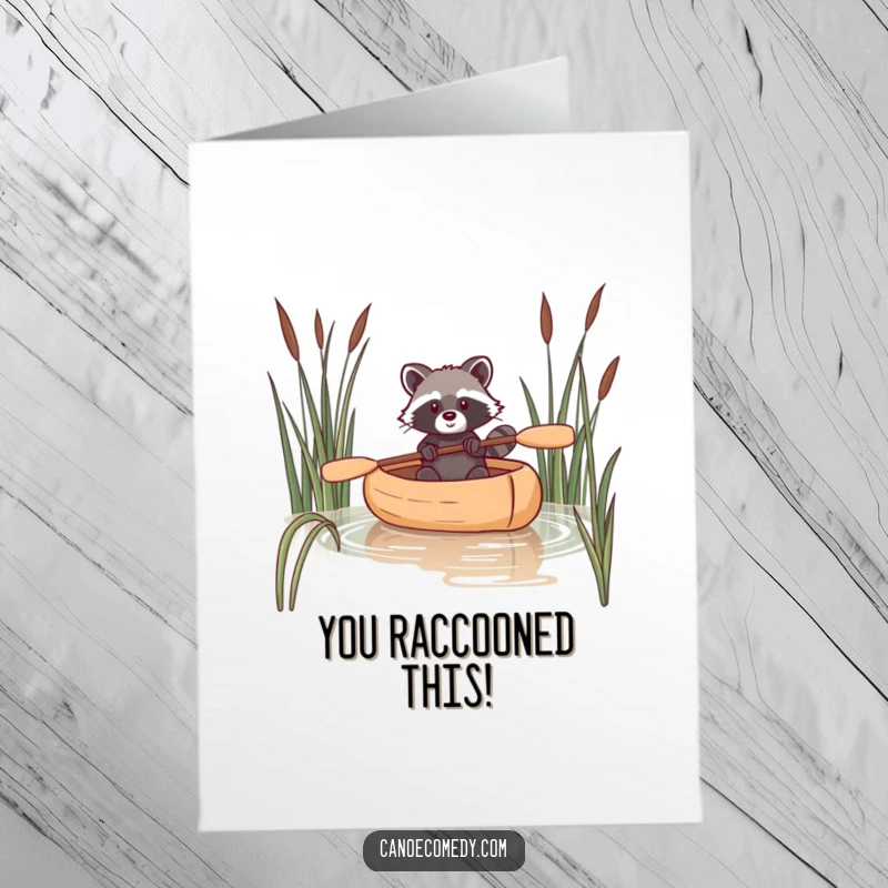 Funny Free Printable Congratulations Card: A mischievous raccoon navigating a canoe through reeds, ideal for a DIY congratulatory message.