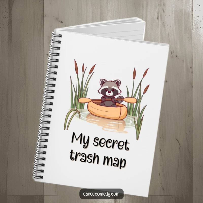 Funny raccoon notebook with a depiction of a raccoon navigating a canoe through reeds, encouraging clever notes.