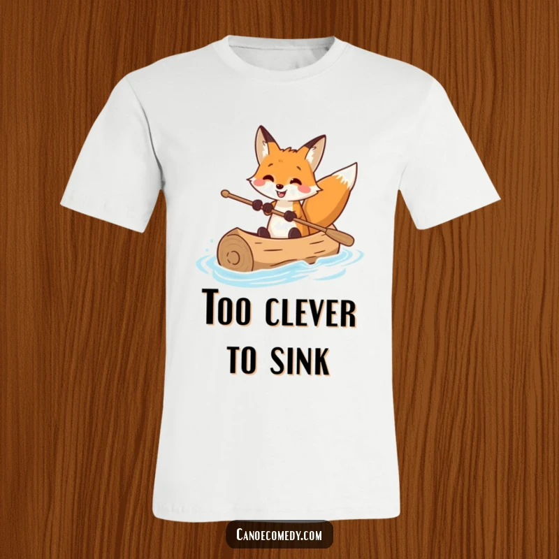 Funny t-shirt displaying a smiling fox masterfully piloting a log canoe, exuding expertise and fun on the water.