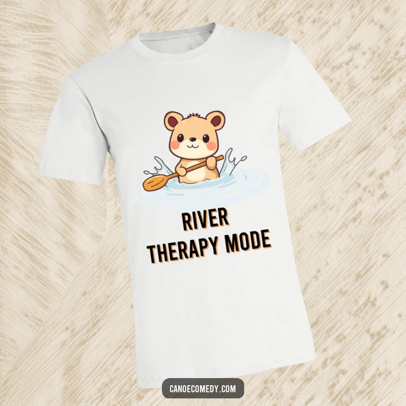 Funny t-shirt featuring a delighted animal vigorously splashing water with a paddle in a tranquil river, radiating sheer aquatic joy.