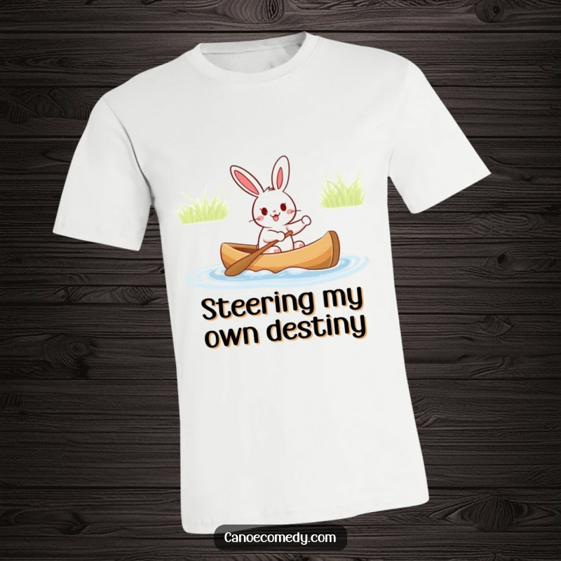 Funny t-shirt showing a happy rabbit steering a canoe with great enthusiasm, perfect for river trips and outdoor fun.