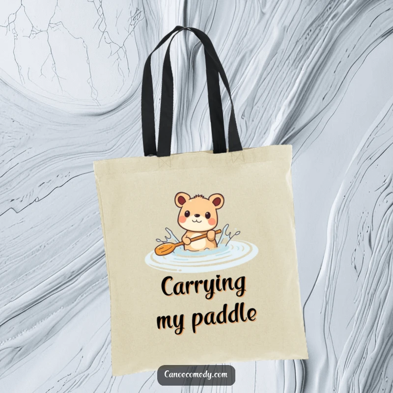 Funny tote bag showing a happy animal enthusiastically splashing with a paddle in a calm river, a symbol of playful adventure.