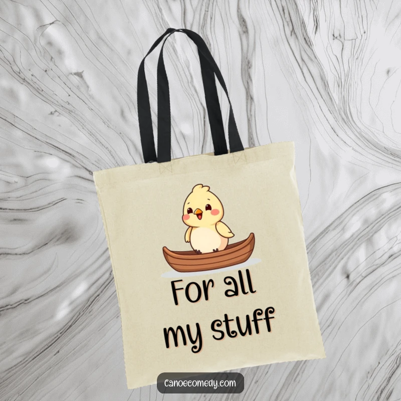 Funny chirpy bird sitting in the front of a canoe, depicted on a tote bag, a perfect funny gift.