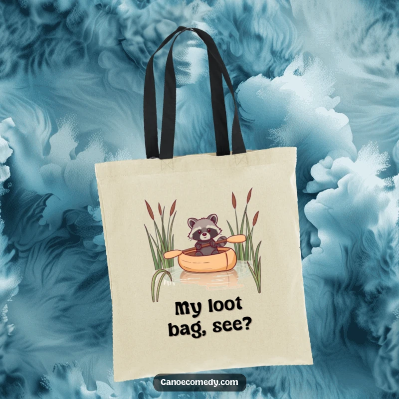 Funny raccoon tote bag featuring a raccoon navigating a canoe through reeds, great for carrying daily necessities with flair.